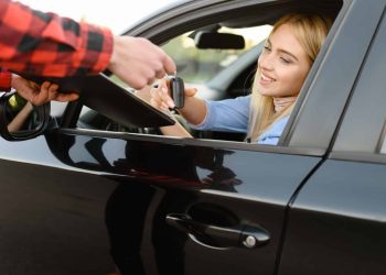 Instructor gives the keys to student in car, exam